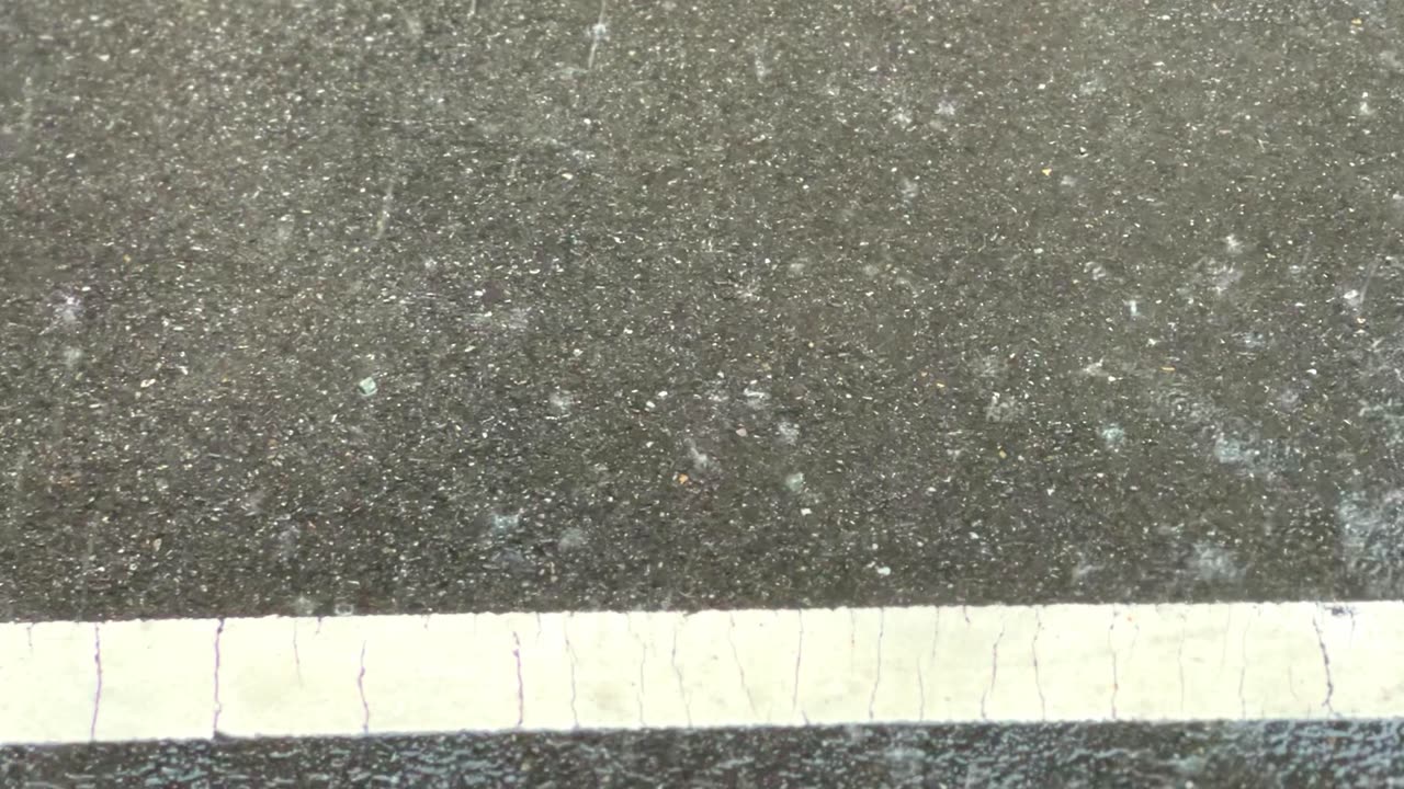 raindrops falling on the asphalt road