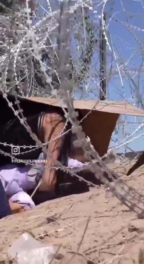 Illegals Moving Child under Razor Wire