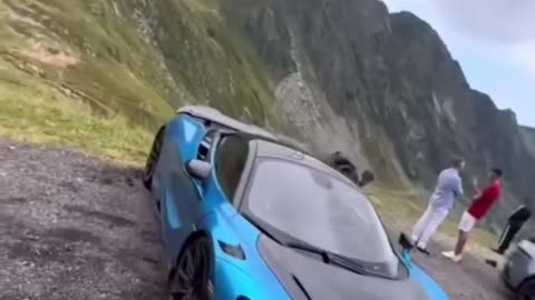 Andrew Tate racing down mountain in super cars