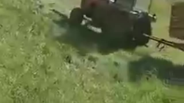 Tractor Trying to Drive Uphill Slides Backwards and falls Into Water