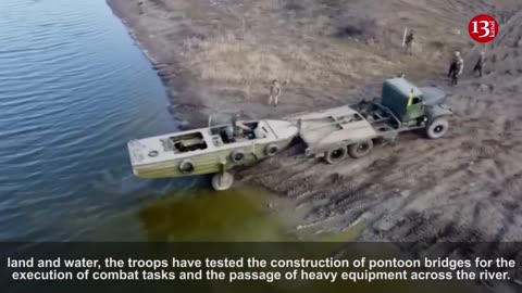 Ukrainian army preparing for battle by transporting heavy artillery across river via pontoon bridge