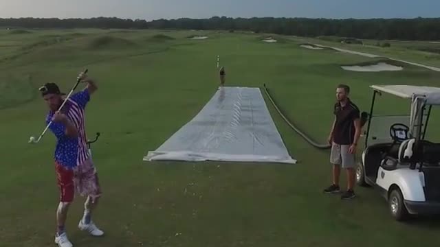 On a very large lawn 2 people were playing golf