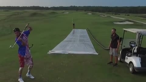 On a very large lawn 2 people were playing golf