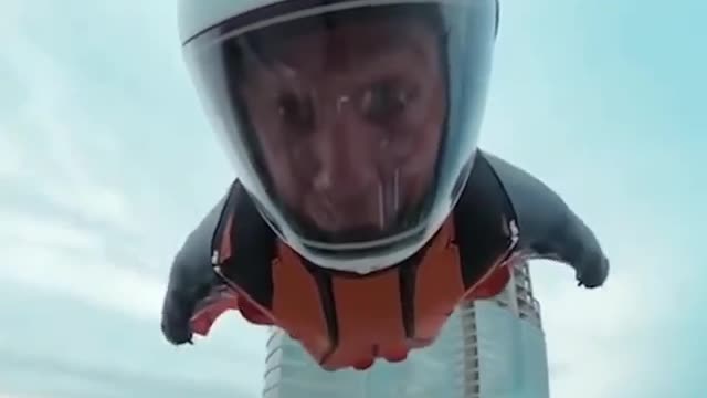 Man doing sky diving from skyscrapers which is amazing