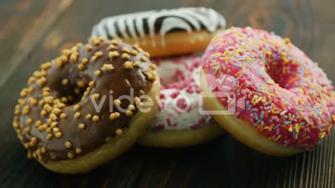 Assortment of donuts with different decor-From above sweet tasty donuts with different glazing on wo