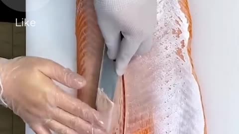 Guy cuts and slices a big salmon to perfection!