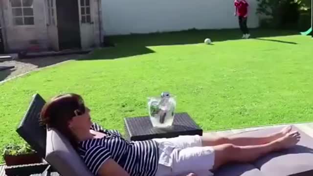 Kid hits his mom with a soccer ball