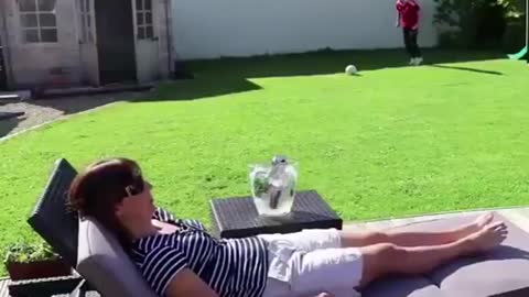 Kid hits his mom with a soccer ball