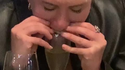 Woman Drinks Champagne by the Mouthful