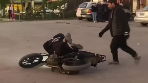 dude drops the motorbike trying wheely and it goes from bad to worse