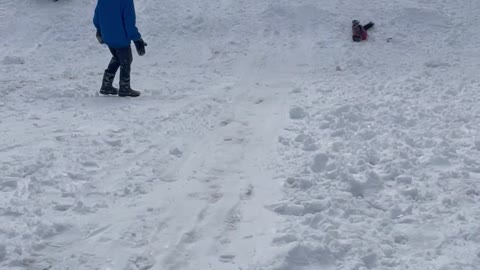 Catching Air Sledding Down a Snowy Slope