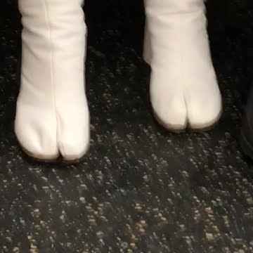 Woman wears horse toe boot on subway