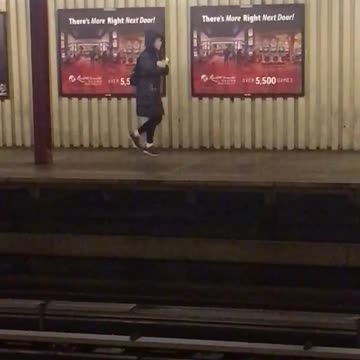Hoodie woman does odd dance while waiting for subway