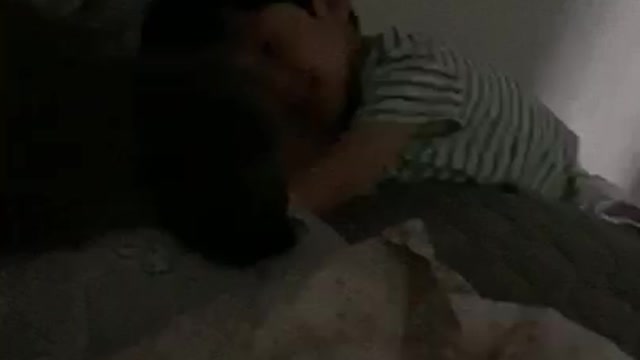 A baby playing with a dog.