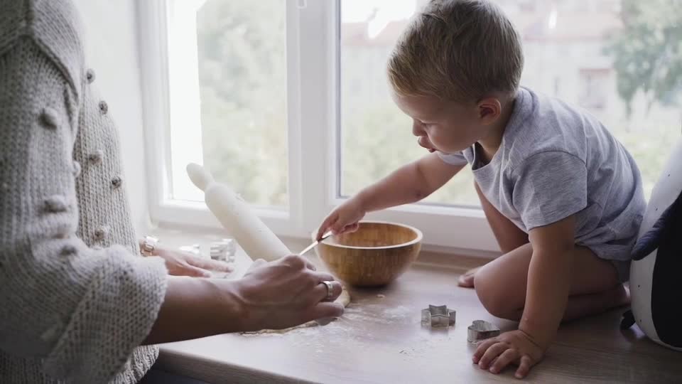 Little Baby helping mommy in the Kitchen.