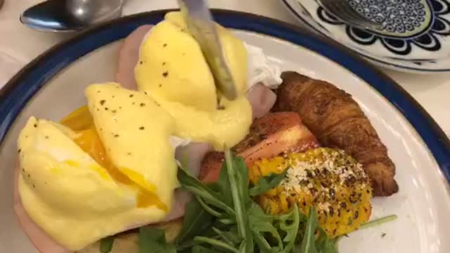 Classic, egg benedict cutting shot.