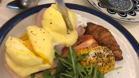 Classic, egg benedict cutting shot.