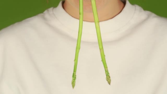 a woman with Asparagus stalks in her nose