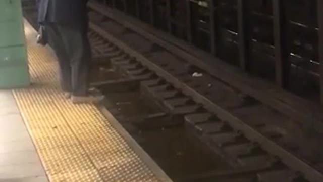 Old guy blue suit fishing subway train tracks