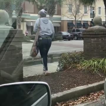 Girl grey sweater walking in front of car