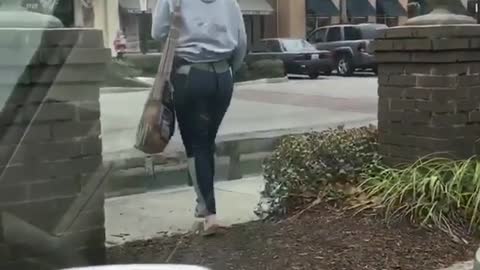 Girl grey sweater walking in front of car