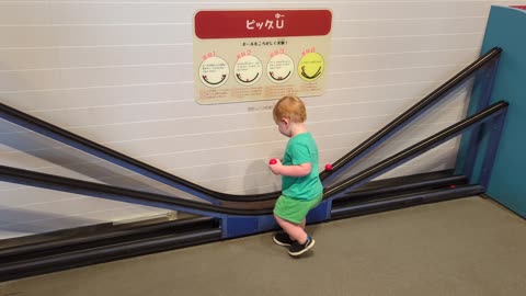 Boy Struggles to Grab Rolling Ball