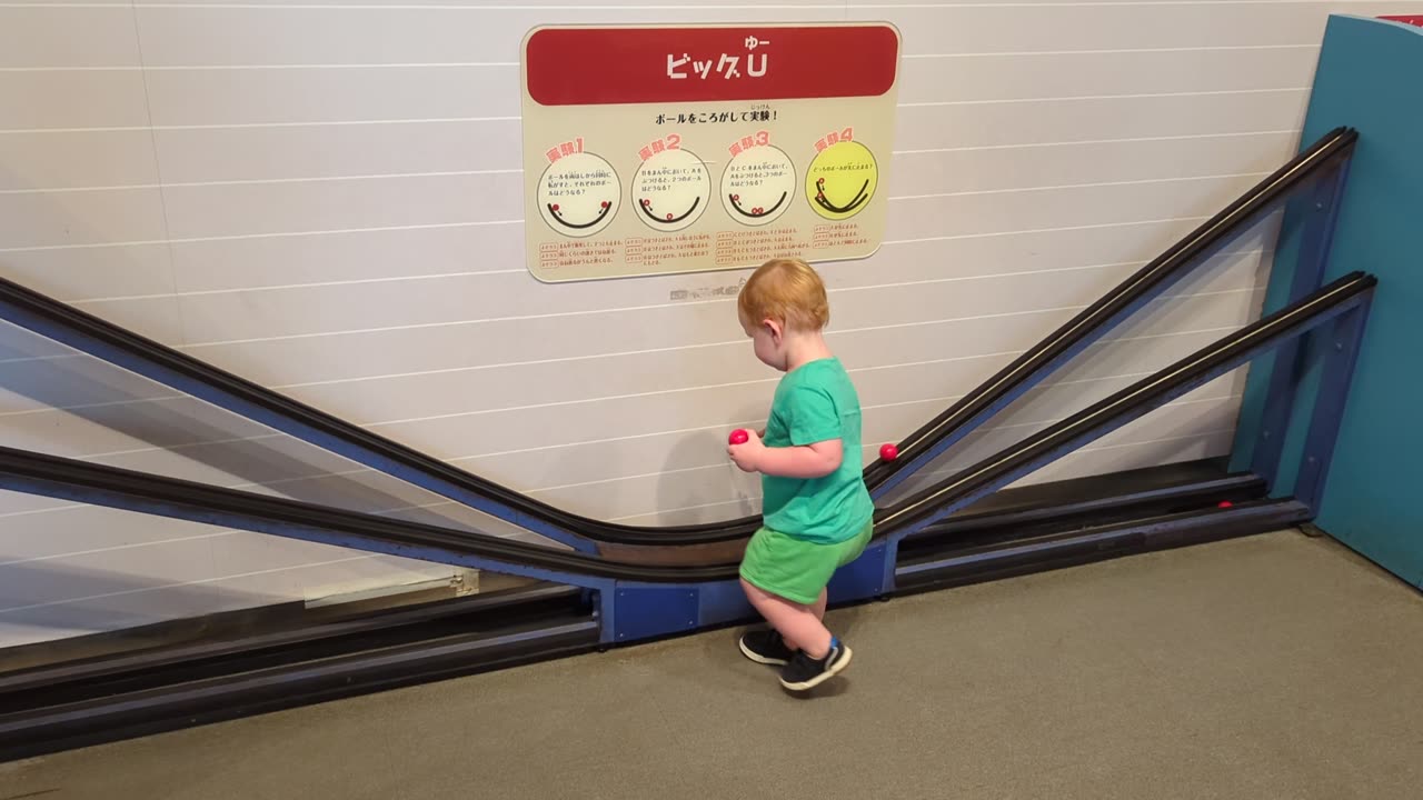 Boy Struggles to Grab Rolling Ball