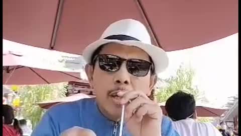 Drink milk from a straw outside the cup