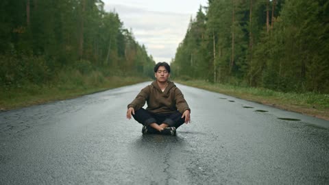 Man Doing Yoga In The Middle Of The Road