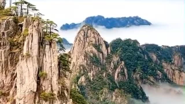 A beautiful view of mountains and white clouds