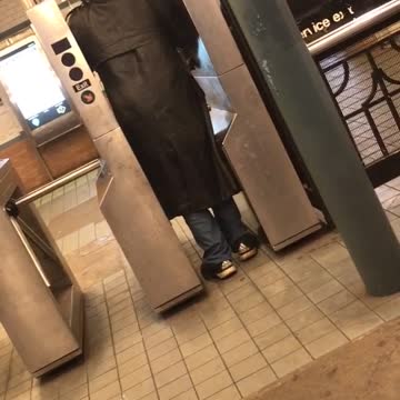 Man on at subway entrance yells