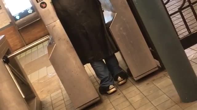 Man on at subway entrance yells