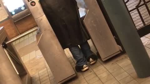 Man on at subway entrance yells