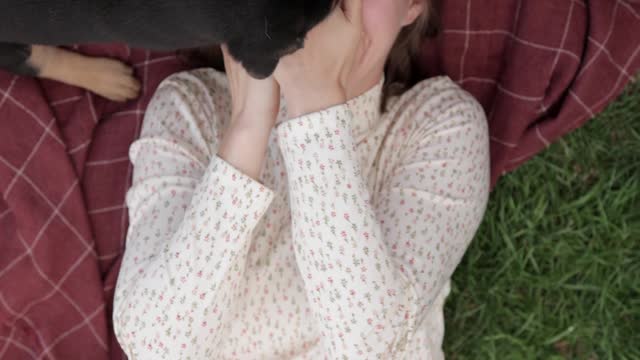 Canines Licking a Woman's Face