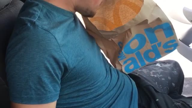 Guy blue shirt throwing up in mcdonalds bag