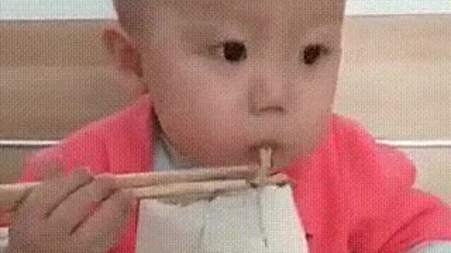 The boy is skillfully controlled with chopsticks