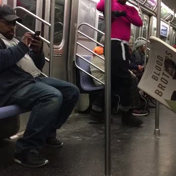 Pink shirt guy practices boxing in subway car