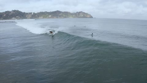 Aerial view of people surfing Aerial shot of surfers in the ocean waiting for waves.