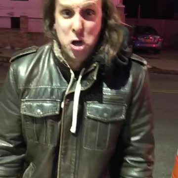 Crazy guy leather jacket complaining about parking signs cones