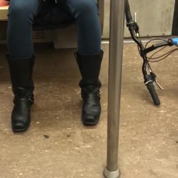 Guy brings his bike on subway train and leaves it lying on the floor