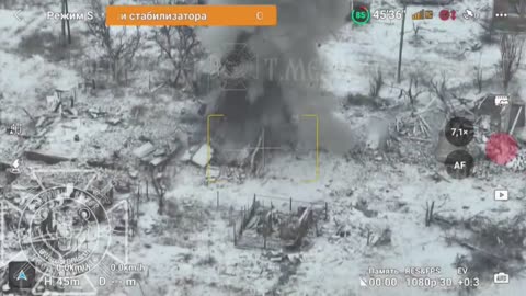 A Russian fighter throws an anti-tank mine at a Ukrainian position in the ruins of a house.