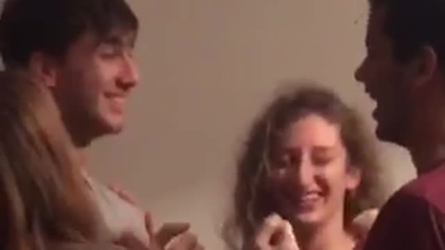 People slapping one another in a group and laughing