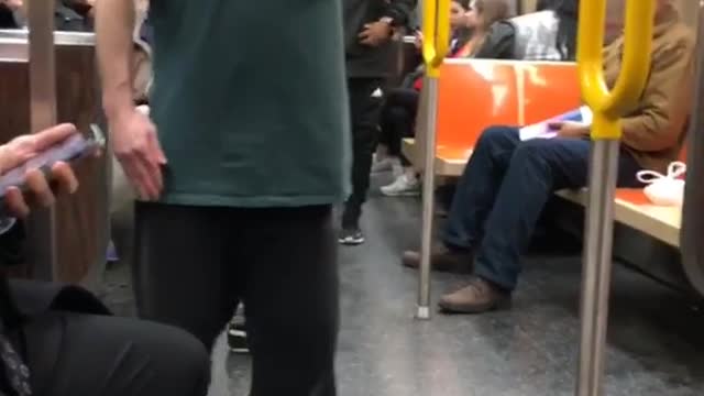 Drunk guy spins around fast inside a subway train