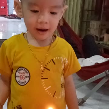 baby blowing out candles