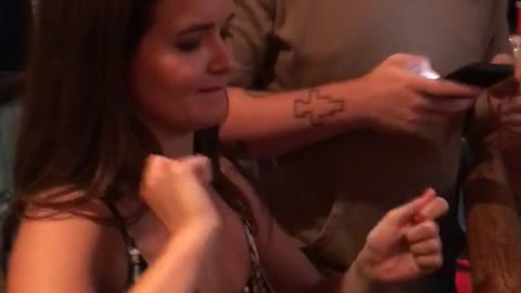 Music girl black shirt pretending to hit drums get hit on head by guy