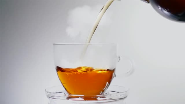 Pouring Tea On Teacup