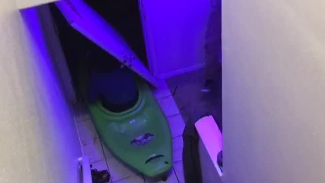 Guy in green kayak slides down stairs