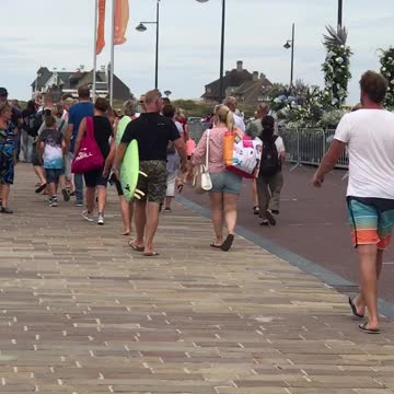 Man carrying bright green surf board