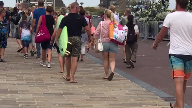 Man carrying bright green surf board