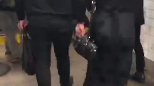 People wearing disco balls as hats in subway station